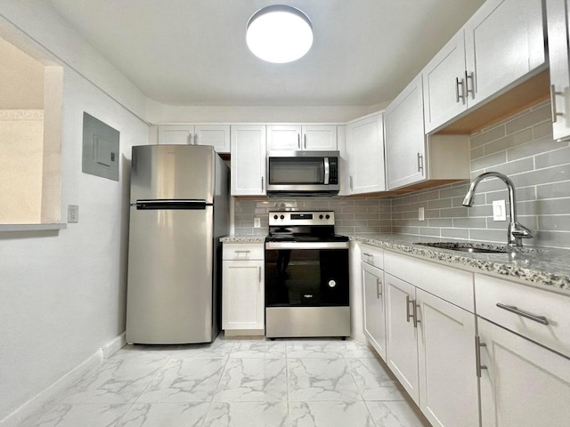 kitchen featuring sink, white cabinetry, stainless steel appliances, and tasteful backsplash