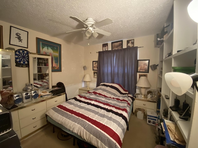 bedroom with a textured ceiling and ceiling fan