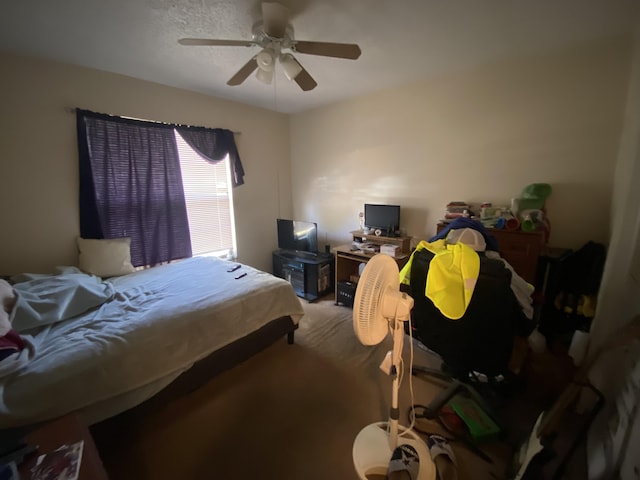 bedroom featuring ceiling fan and carpet