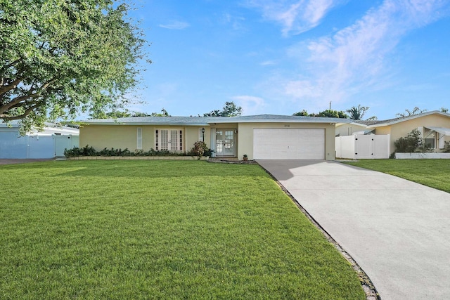 ranch-style house with french doors, a front yard, and a garage