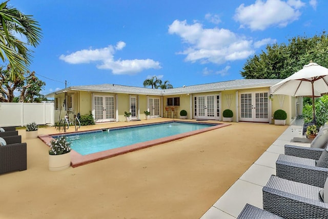 view of swimming pool featuring a patio area and french doors