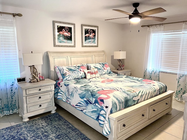 bedroom with ceiling fan and light tile patterned floors