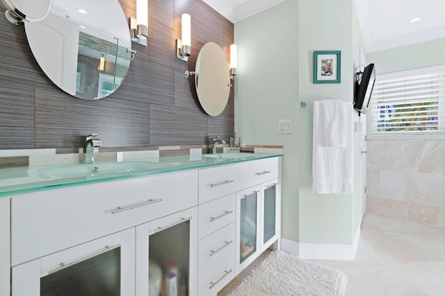 bathroom featuring vanity, crown molding, and tile walls