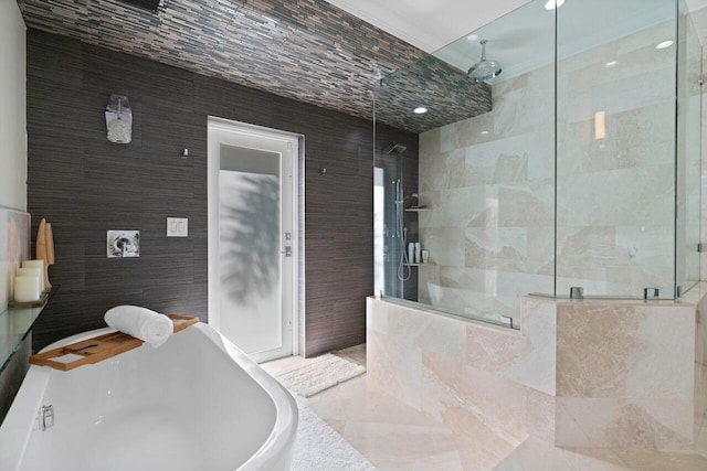 bathroom featuring plus walk in shower and tile walls