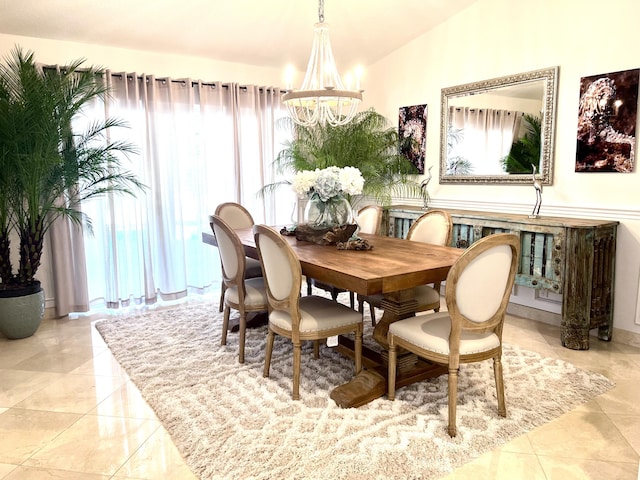 dining space featuring a chandelier, lofted ceiling, and light tile patterned flooring