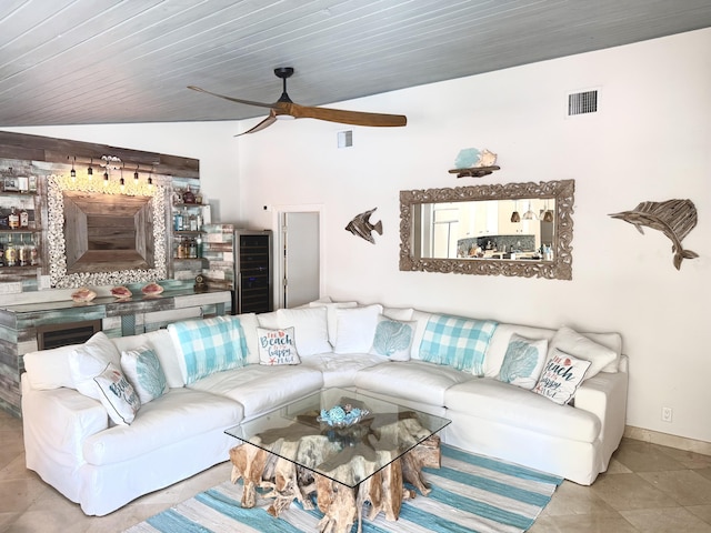 tiled living area with a ceiling fan, wine cooler, visible vents, and lofted ceiling