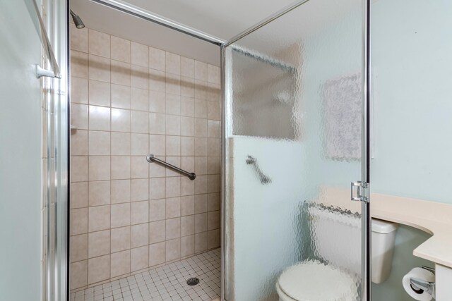 bathroom with toilet and a shower with shower door