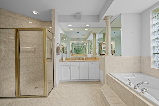 bathroom featuring tile patterned floors, vanity, ornate columns, and shower with separate bathtub