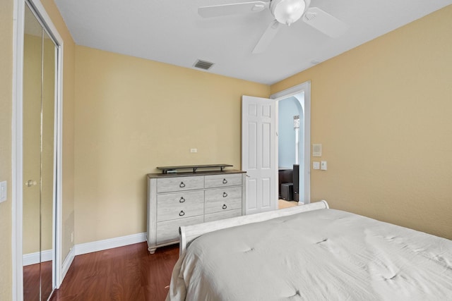 bedroom featuring ceiling fan, dark hardwood / wood-style flooring, and a closet