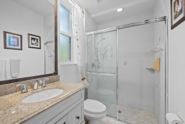 bathroom with walk in shower, vanity, and toilet