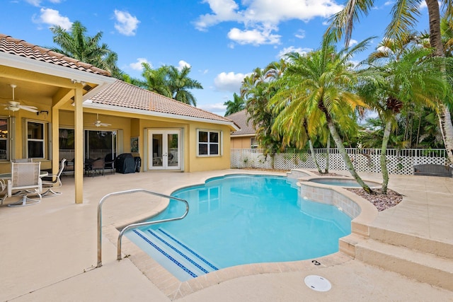 view of pool with ceiling fan, french doors, a patio, and an in ground hot tub