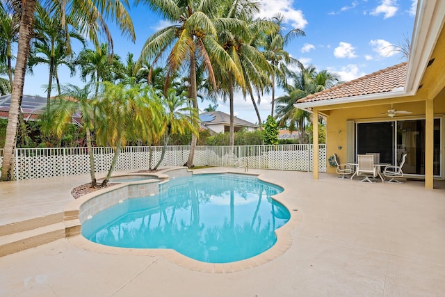 view of swimming pool featuring ceiling fan, an in ground hot tub, and a patio