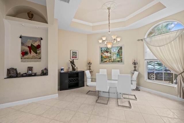 tiled dining area with a tray ceiling, crown molding, a wealth of natural light, and a chandelier