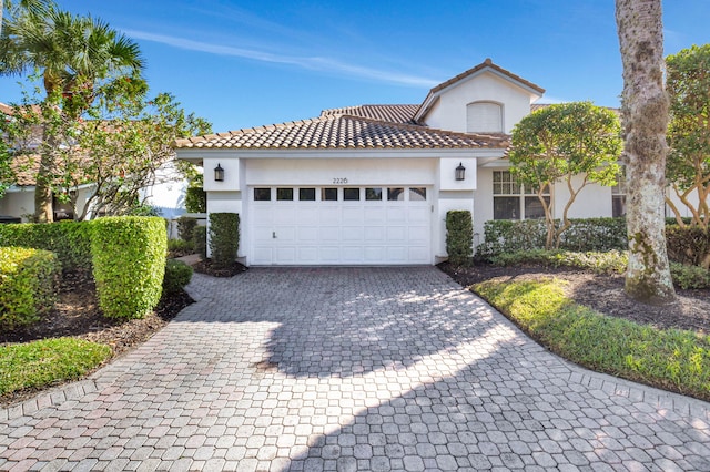 mediterranean / spanish house featuring a garage