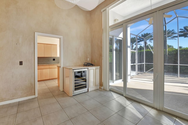 interior space with light tile patterned floors and wine cooler