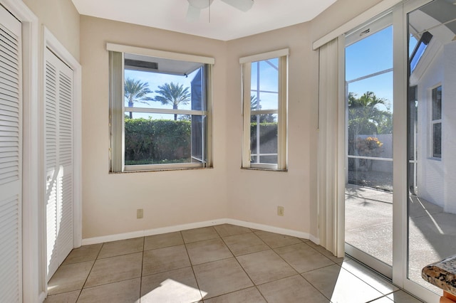 interior space with ceiling fan