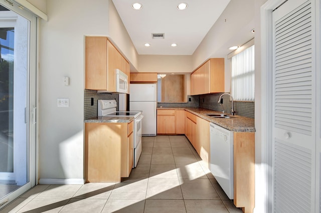 kitchen with decorative backsplash, sink, white appliances, and light brown cabinets