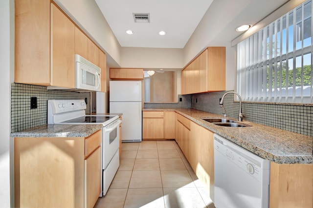 kitchen with white appliances, backsplash, sink, light brown cabinetry, and light tile patterned flooring