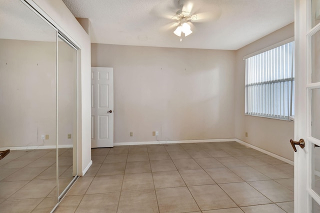 interior space featuring a textured ceiling and ceiling fan