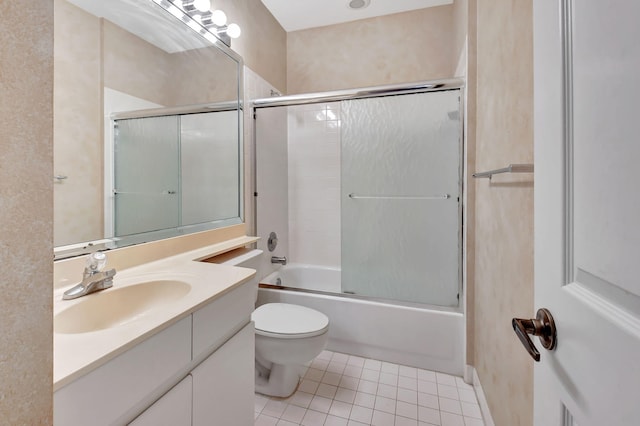 full bathroom with tile patterned flooring, vanity, toilet, and enclosed tub / shower combo