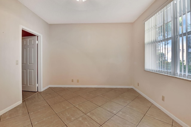 tiled empty room featuring a wealth of natural light