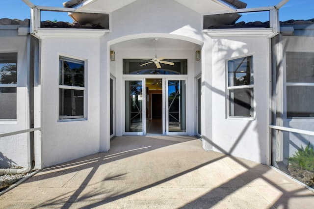 property entrance featuring ceiling fan and a patio