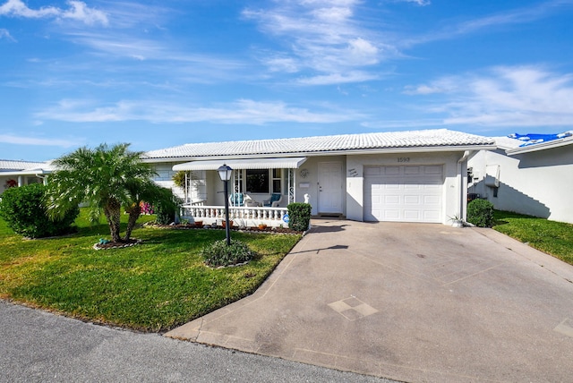 ranch-style home with covered porch, a garage, and a front lawn