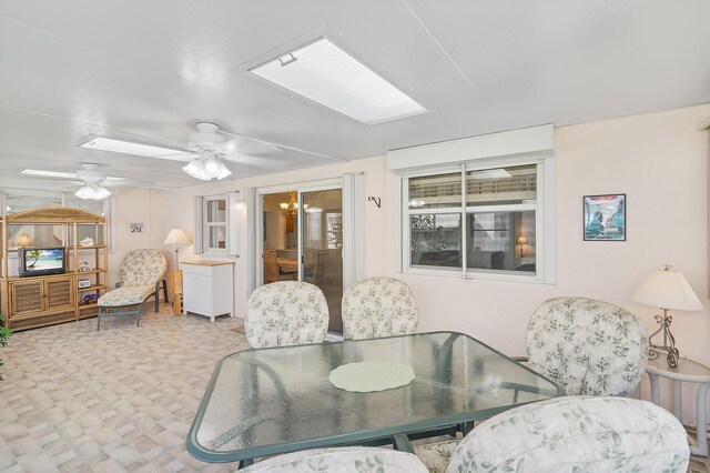 carpeted living room with a textured ceiling, ceiling fan, and crown molding