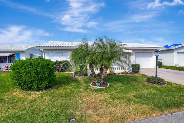 view of front of property with a garage and a front lawn