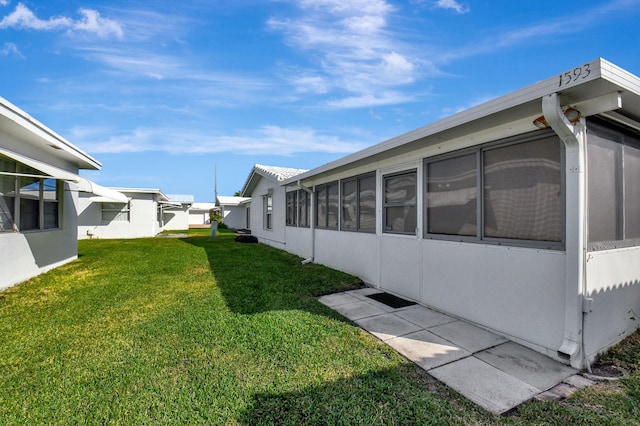 view of yard featuring a sunroom