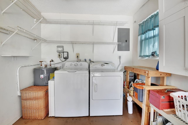 clothes washing area featuring washing machine and dryer, water heater, electric panel, and a textured ceiling