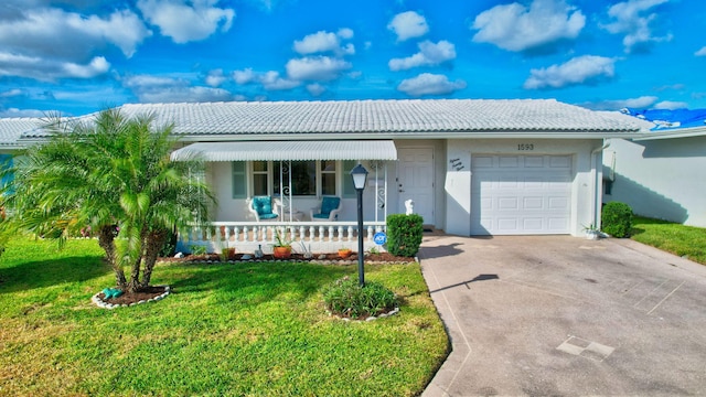 ranch-style home featuring a front lawn and a garage