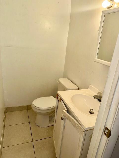 bathroom with tile patterned flooring, vanity, and toilet