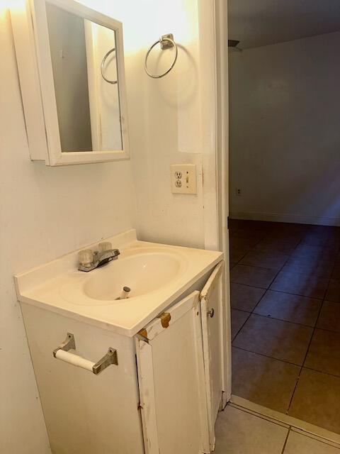 bathroom with tile patterned flooring and vanity