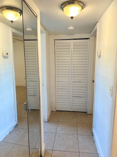 corridor featuring light tile patterned flooring