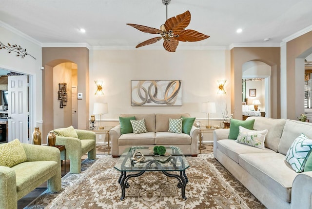 living room featuring ceiling fan and crown molding