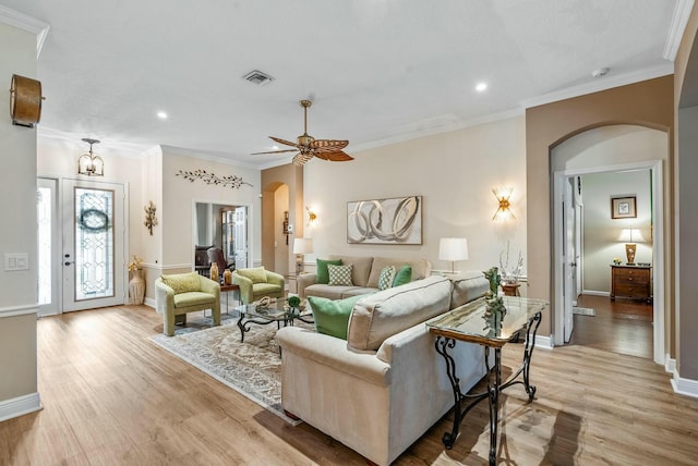 living room with ceiling fan, light hardwood / wood-style flooring, and ornamental molding