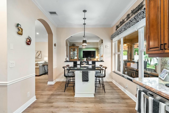 dining space with light hardwood / wood-style floors, radiator heating unit, and crown molding