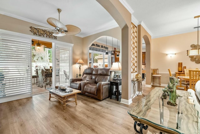 living room with light hardwood / wood-style flooring, ceiling fan, and ornamental molding