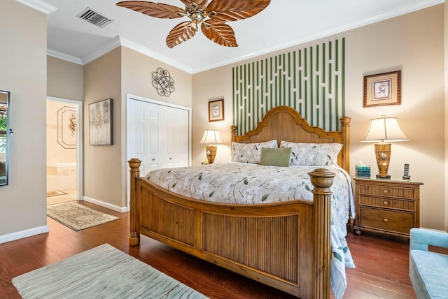 bedroom featuring ensuite bath, ornamental molding, ceiling fan, dark hardwood / wood-style floors, and a closet