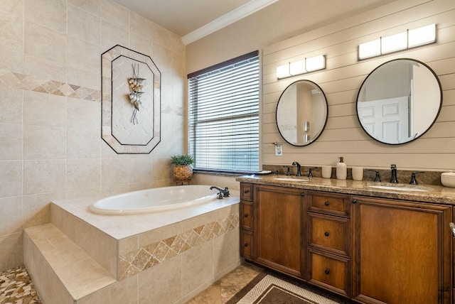 bathroom featuring tiled tub, crown molding, and vanity