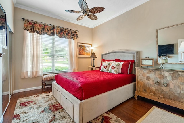 bedroom with dark hardwood / wood-style flooring, ceiling fan, and crown molding