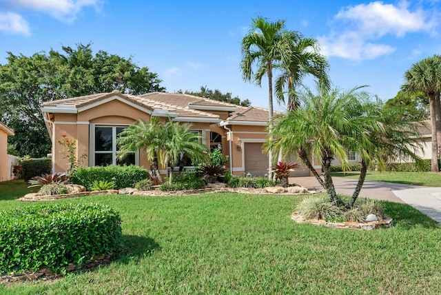 view of front of property featuring a garage and a front lawn