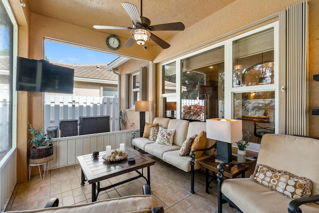 sunroom / solarium featuring ceiling fan