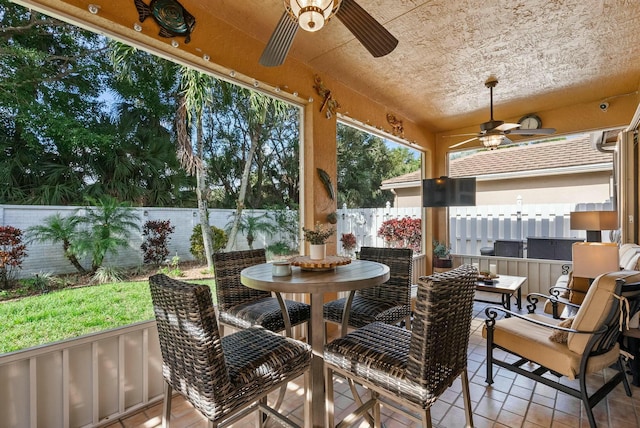 sunroom / solarium with ceiling fan