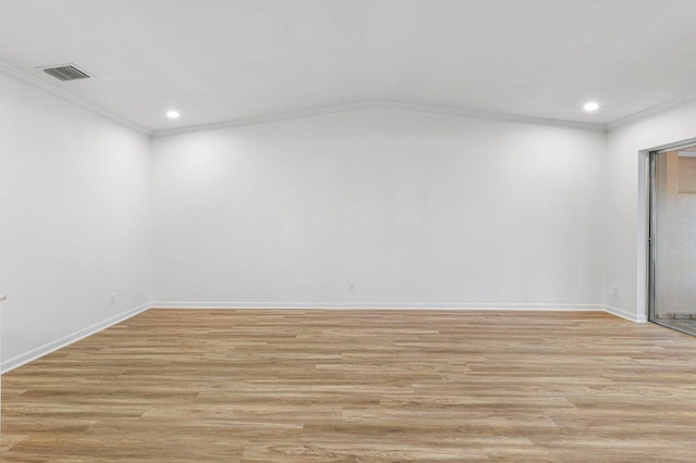 empty room featuring crown molding and light hardwood / wood-style flooring