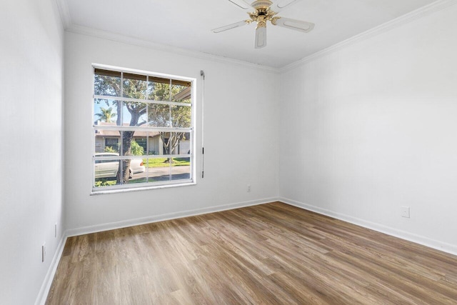 spare room with hardwood / wood-style floors, ceiling fan, and ornamental molding