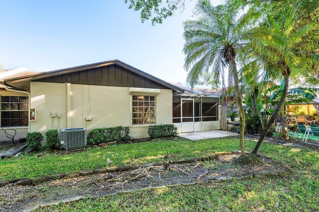 back of house featuring a lanai, a yard, and cooling unit