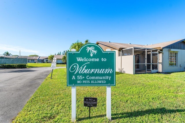 community / neighborhood sign with a lawn