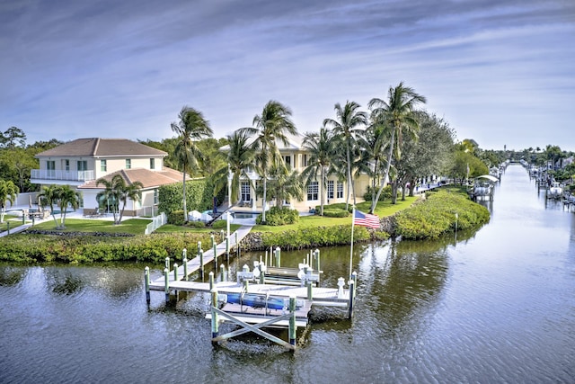 view of dock with a water view and a yard